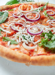 Delicious classic Italian pizza with tomatoes on a light background