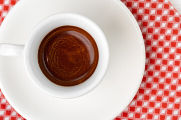 Cup of espresso coffee on saucer close up
