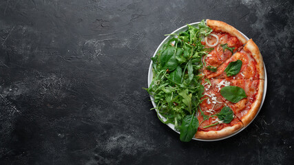 Tasty appetizing vegetarian pizza on dark stone background, top view 