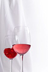 Wine fuses with red liquid on a white background, vertical image