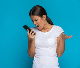 attractive casual woman screaming at the phone