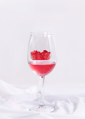 Wine fuses with red liquid on a white background, vertical image