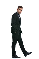 side view of elegant young businessman holding hands in pockets