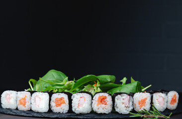 Sushi rolls with rice, herbs and soy sauce, close-up