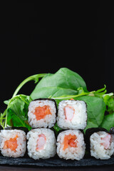 Sushi rolls with rice, herbs and soy sauce, close-up