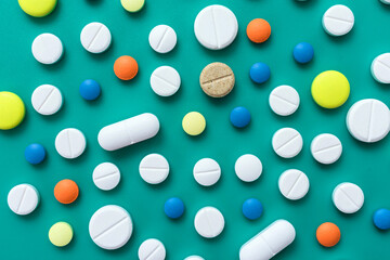 
Various pills on blue background, flat lay.Medicine background.