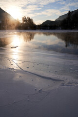 The river is about to freeze. It is very cold and the river is much warmer than the air, therefore the smoke or the damp from the river. Shot at Gol, Norway in February. Minus 20 degreases Celsius.  © SteinOve