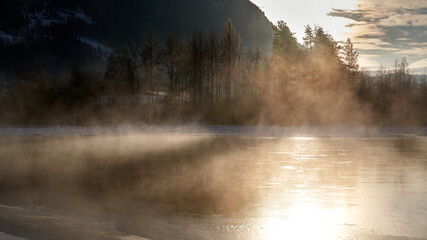 The river is about to freeze. It is very cold and the river is much warmer than the air, therefore the smoke or the damp from the river. Shot at Gol, Norway in February. Minus 20 degreases Celsius.  © SteinOve