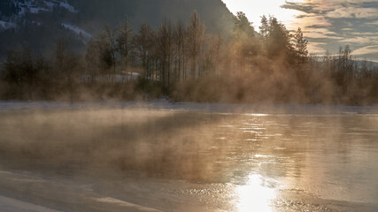 The river is about to freeze. It is very cold and the river is much warmer than the air, therefore the smoke or the damp from the river. Shot at Gol, Norway in February. Minus 20 degreases Celsius.  © SteinOve