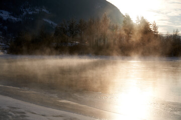 The river is about to freeze. It is very cold and the river is much warmer than the air, therefore the smoke or the damp from the river. Shot at Gol, Norway in February. Minus 20 degreases Celsius.  © SteinOve