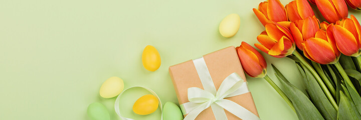 Stylish background with colorful easter eggs pastel colors isolated on green background. Horizontal long banner for web design. Flat lay, top view, mockup, overhead, template