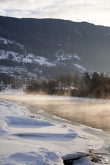 The river is about to freeze. It is very cold and the river is much warmer than the air, therefore the smoke or the damp from the river. Shot at Gol, Norway in February. Minus 20 degreases Celsius.  © SteinOve