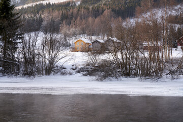 The river is about to freeze. It is very cold and the river is much warmer than the air, therefore the smoke or the damp from the river. Shot at Gol, Norway in February. Minus 20 degreases Celsius.  © SteinOve