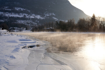 The river is about to freeze. It is very cold and the river is much warmer than the air, therefore the smoke or the damp from the river. Shot at Gol, Norway in February. Minus 20 degreases Celsius.  © SteinOve