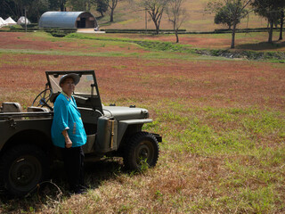 asian old elderly elder senior woman posing with old classic antique retro car