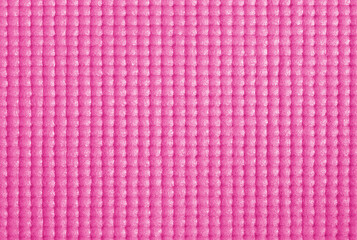 Texture of pink color yoga mat for background and design art work.
