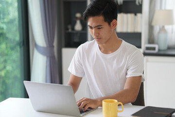 asian young student man entrepreneur working with computer studying learning online at home....