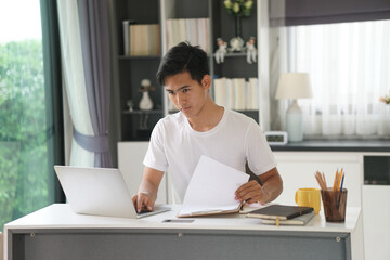 asian young student man entrepreneur working with computer studying learning online at home....