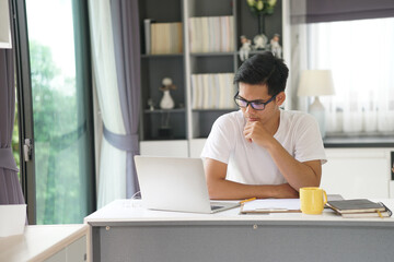 asian young student man entrepreneur working with computer studying learning online at home....