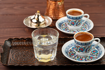 Cup of coffee in oriental style on metal tray