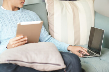 asian young student man entrepreneur working with tablet computer studying learning online at home....