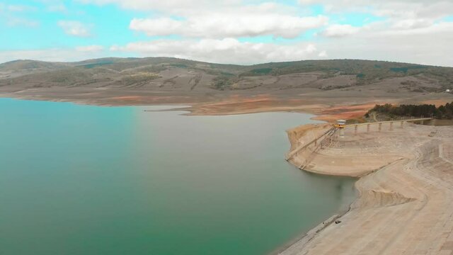 Aerial view of Sioni dam construction with people fishing in Georgia, caucasus