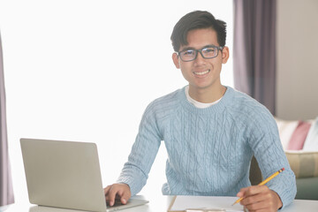asian young student man entrepreneur working with computer studying learning online at home....