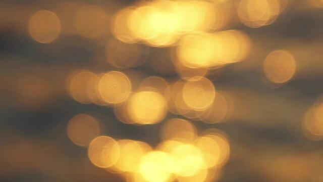 Sunset light reflection on sea surf surface, Bokeh light blurred background