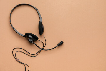 Headphones with microphone on color background