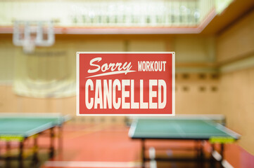 inscription sorry workout canceled. gym restrictions during quarantine. Naturally blurred interior...