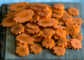 cut orange carrot slices on a wooden pallet,