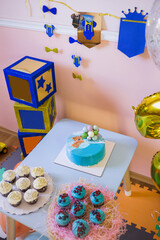 
A blue cake with a bear and balls on the background of a children's holiday - birthday.