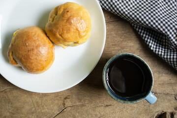 Home made bread with coffee cup on old rustic wood table.Top view.