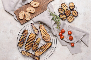 Tasty grilled eggplant on grey background