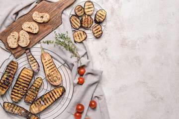 Tasty grilled eggplant on grey background