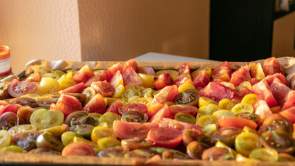 tray with sliced tomatoes, different colors and shapes, autumn harvest