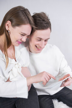 Young couple watching ultrasound of the unborn child