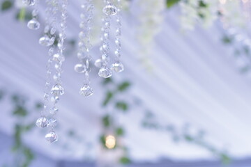 Crystal chandelier. Big classic crystals. Low angle shot of a big beautiful crystal luxury chandelier. With bling bling shining reflection.