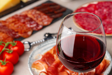 Meat slicing and wine on gray background