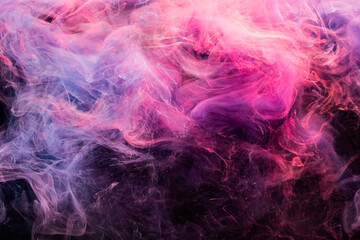 Ink in water. Colorful background. Creative smoke cloud design. Harmony transformation. Glowing bright pink violet fog spreading on dark.