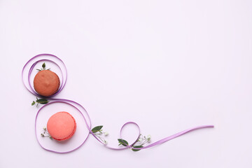Figure 8 made of violet ribbon and macarons on white background. International Women's Day celebration