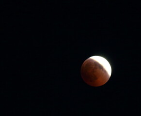 evocative image of moon eclipse at night up in the sky
