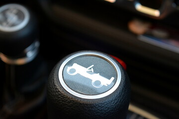 close up of a gear knob of an all wheel drive vehicle with a suv symbol