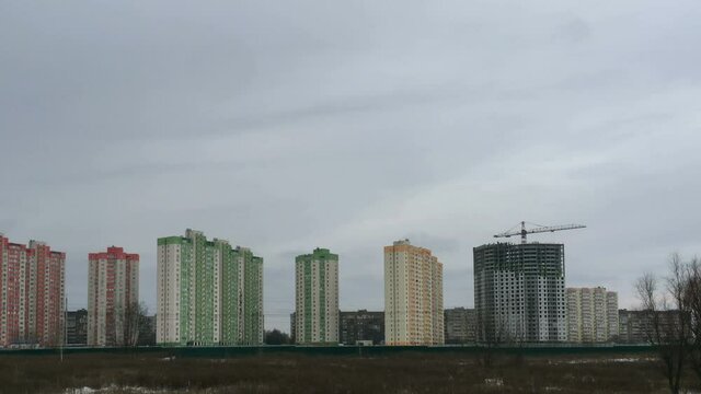 Typical modern high-rise buildings in residential complex on outskirts of Brovary, Ukraine. Housing and city expansion. Dolly shot from left to right. Wide shot.