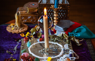 Candle burns a herb on the altar, magic among candles, clean negative energy, wicca  concept