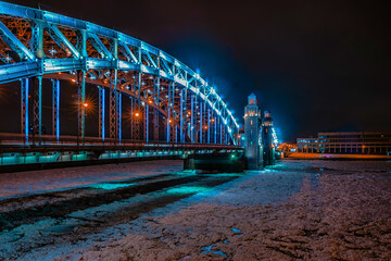Bolsheokhtinsky Bridge through the Neva River. St. Petersburg in the winter evening. Evening city lighting