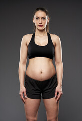 Fototapeta na wymiar Pregnant bodybuilder lady working out