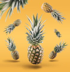 Fresh ripe pineapple with leaves falling in the air on the yellow background. fresh fruit levitation concept.