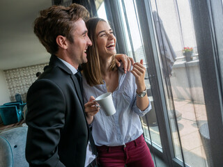 Handsome man and attractive woman are spending time together. Taking coffee break and communicating.