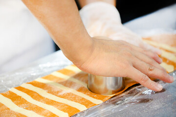 Chef cutting pasta dough preparing shapes for ravioli